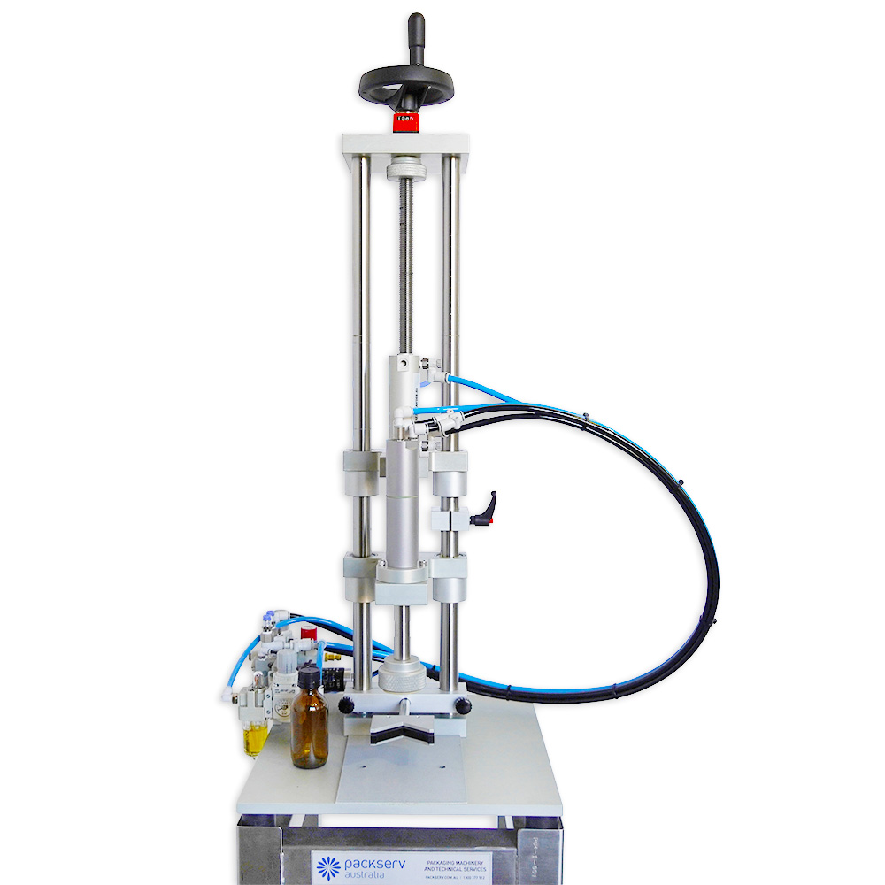 Packserv PCM-1 Bench Model Capper positioned above a stainless steel trolley for mobile operation