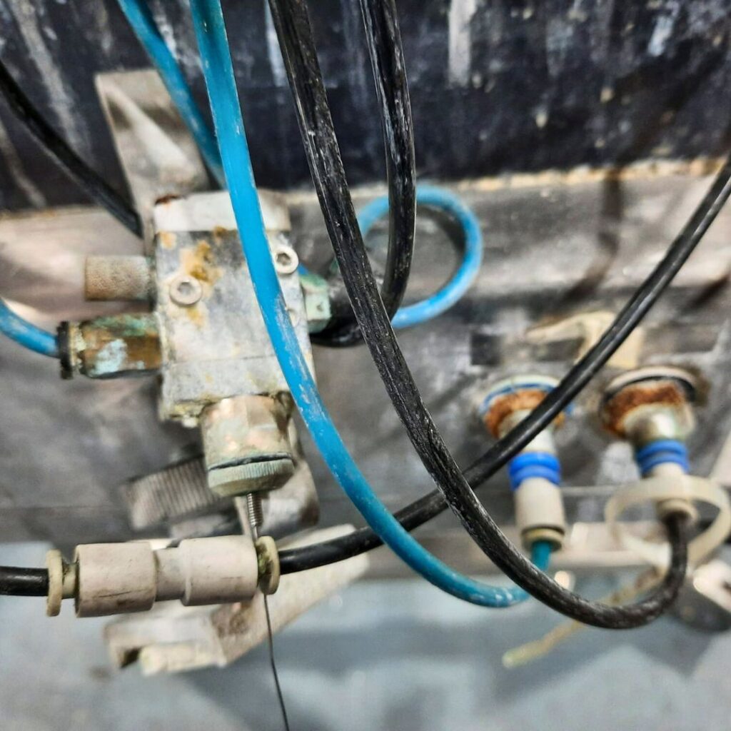 Close-up of pneumatic system components showing damage from moisture and particles.