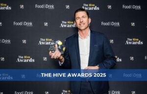 Nathan Wardell wins The Hive Award 2025, holding a framed certificate at a Packserv Australia event.