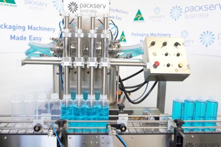 PFM-4C liquid filler machine by Packserv Australia with stainless steel design and multi-head filling nozzles.